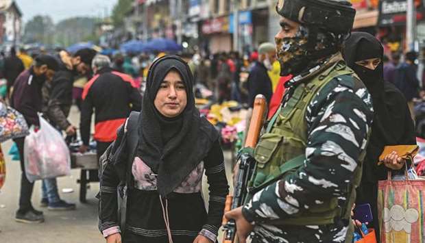 An Indian paramilitary trooper stands guard at a market in Srinagar yesterday.