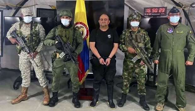 Members of the Colombian Army escorting Colombia's most-wanted drug lord and head of the Gulf Clan, Dairo Antonio Usuga (C) -alias 'Otoniel'-, after his capture in Bogota. Photo by Handout/Colombian army/AFP