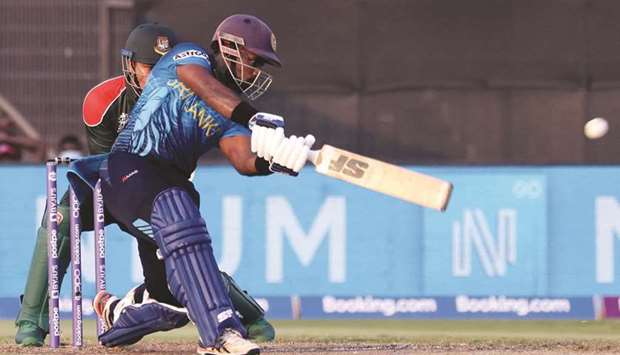 Sri Lankau2019s Charith Asalanka plays a shot during the ICC menu2019s Twenty20 World Cup match against Bangladesh at the Sharjah Cricket Stadium yesterday. (AFP)