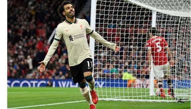 Liverpool's Egyptian midfielder Mohamed Salah celebrates after scoring their fifth goal, his third during the English Premier League football match between Manchester United and Liverpool.