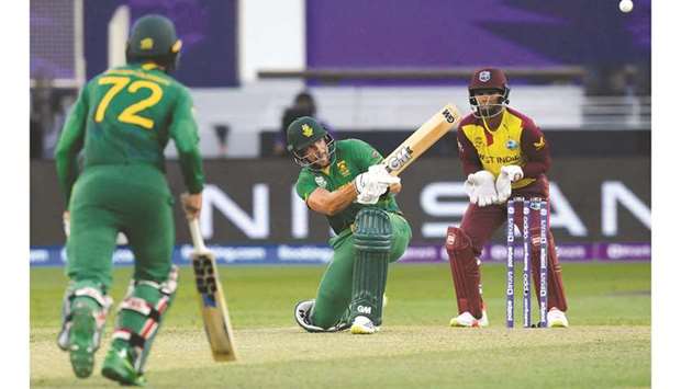 South Africau2019s Aiden Markram (centre) plays a shot during the ICC menu2019s Twenty20 World Cup match against West Indies at Dubai International Cricket Stadium in Dubai yesterday. (AFP)