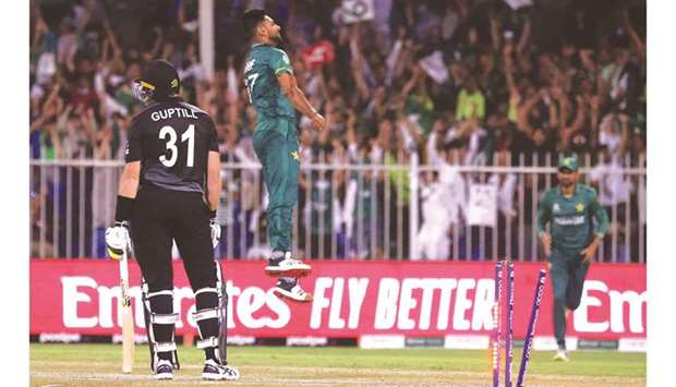 New Zealandu2019s Martin Guptill (left) reacts after being bowled out by Pakistanu2019s Haris Rauf (centre) during the ICC menu2019s Twenty20 World Cup match at the Sharjah Cricket Stadium in Sharjah yesterday. (AFP)