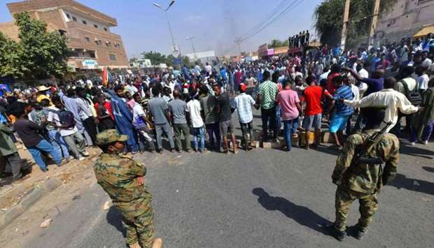 Sudanese security forces keep watch during protests against a military coup that overthrew the transition to civilian rule, yesterday in the capital Khartoum's twin city of Omdurman
