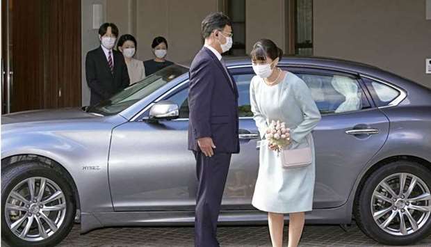 Japan's Princess Mako (R) bows before leaving her home at Akasaka Estate in Tokyo on Tuesday