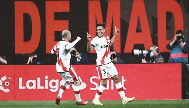 Rayo Vallecanou2019s Radamel Falcao (right) celebrates with teammate Isi Palazon after scoring their first goal against Barcelona in Madrid yesterday. (Reuters)