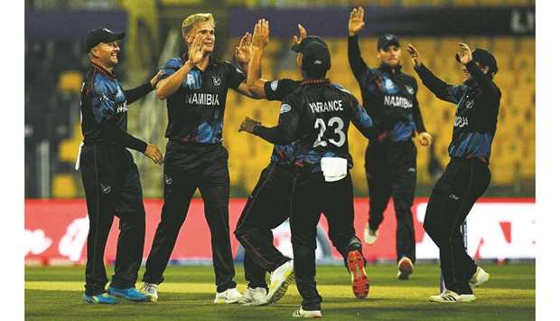 Namibiau2019s Ruben Trumpelmann (second from left) celebrates after the dismissal of Scotlandu2019s Calum MacLeod (not pictured) during the ICC menu2019s Twenty20 World Cup match at the Sheikh Zayed Cricket Stadium in Abu Dhabi yesterday. (AFP)