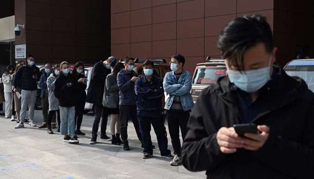 People line up to be tested for the Covid-19 coronavirus at a hospital in Beijing