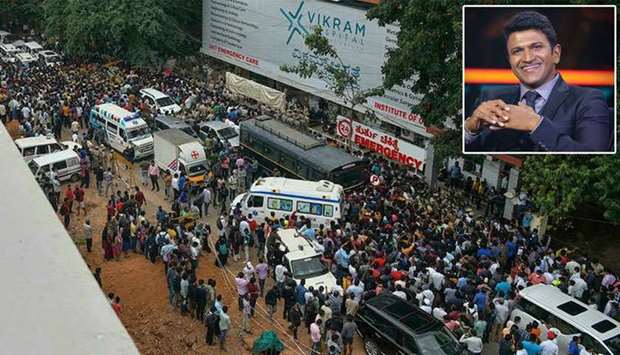Thousands of bereaved cinema fans thronged the streets of Bangalore on Friday after the sudden death of regional Indian film star Puneeth Rajkumar (inset: Twitter/PuneethRajkumar)