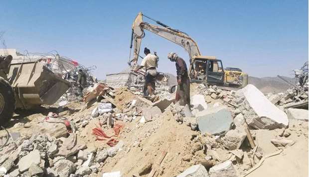 Yemeni workers clear yesterday, rubble of a house belonging to a tribal leader that was targeted in a missile attack by Yemeni rebels the previous day, in the town of El-Juba, south of the strategic city of Marib.