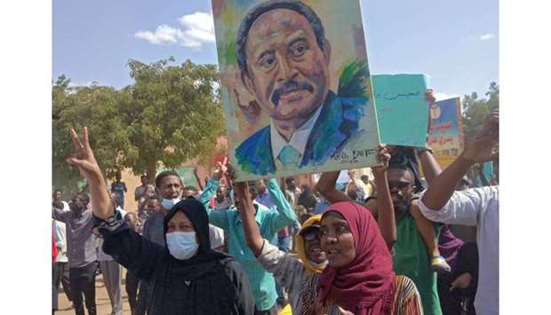 Sudanese anti-coup protesters carry the portrait of Prime Minister Abdalla Hamdok, ousted by the military, during a gathering in the capital Khartoum's twin city of Omdurman, to express their support for the country's democratic transition which a military takeover and deadly crackdown derailed. AFP