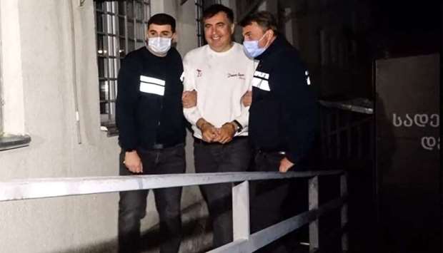 This screengrab made from an handout video released by Georgia's Interior Ministry shows former Georgia's President Mikheil Saakashvili escorted by police officer as he was detained in Tbilisi on October 1, following his arrest upon his return from exile ahead of local elections in the Caucasus country gripped by a protracted political crisis. AFP/Georgia Interior Ministry