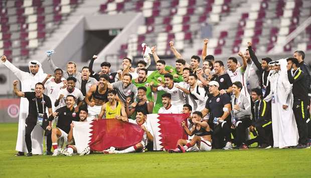 Qatar players and officials celebrate after securing a spot in the AFC U-23 Asian Cup in Uzbekistan following at the Khalifa International Stadium on Sunday. PICTURE: Noushad Thekkayil