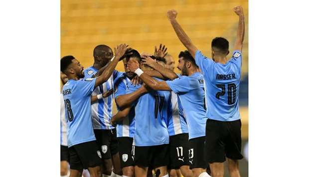 Al Wakrah's Abdulghani Muneer (centre) is mobbed by his teammates after he scored a goal against Al Gharafa during the QNB Stars League match on Sunday.