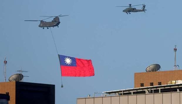 A Taiwan flag is carried across the sky during a national day rehearsal in Taipei, Taiwan