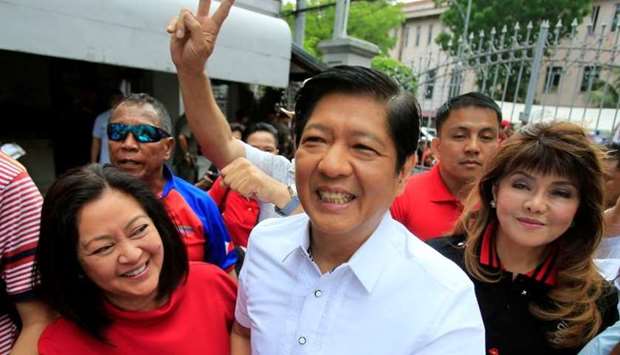 Ferdinand ,Bongbong, Marcos, son of late dictator Ferdinand Marcos, his wife, Louise (L) and his sister Imee (R) smile upon arrival at the Supreme Court in Padre Faura, Metro Manila, Philippines April 2, 2018. REUTERS