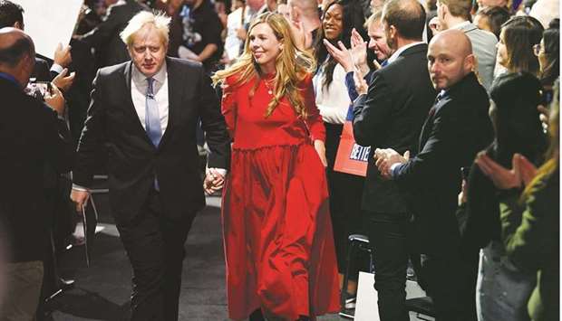 Britainu2019s Prime Minister Boris Johnson departs with his wife Carrie Johnson after delivering a speech during the annual Conservative Party Conference, in Manchester, Britain, yesterday.