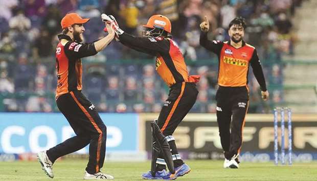 Sunrisers Hyderabadu2019s Kane Williamson (left) and Wriddhiman Saha (centre) celebrate the wicket of Glenn Maxwell of Royal Challengers Bangalore during their IPL match at the Sheikh Zayed Stadium, Abu Dhabi yesterday. (Sportzpics for IPL)