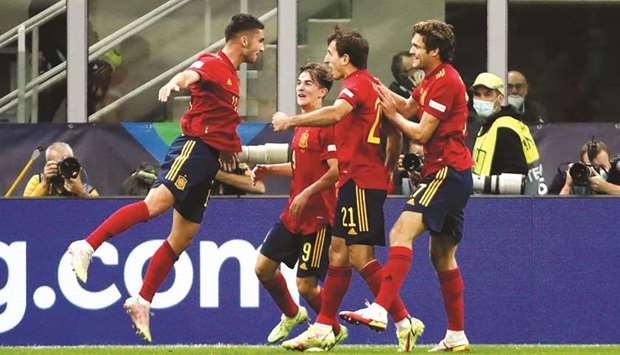 Spainu2019s Ferran Torres (left) celebrates with teammates after scoring against Italy in the Nations League semi-final in Milan. (Reuters)