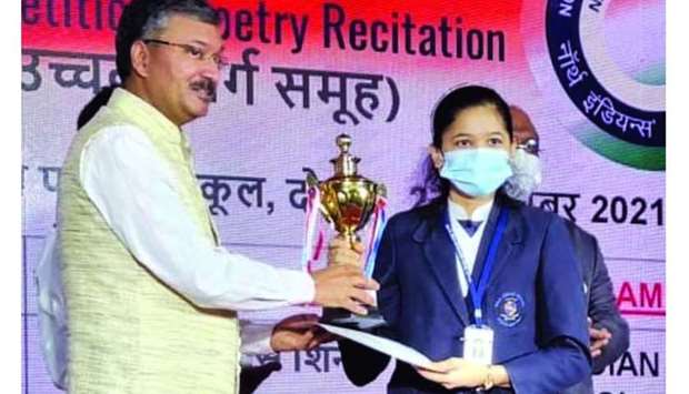 A winner receiving her prize from Indian ambassador Dr Deepak Mittal.