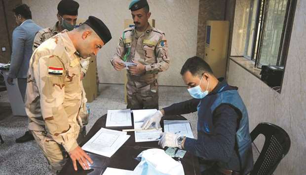 Members of Iraqi Security forces get ready to cast their vote two days ahead of Iraqu2019s parliamentary elections in a special process, in Mosul, yesterday.