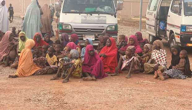 Women and children who were kidnapped in the northwestern state of Zamfara sit after being rescued by the Nigerian security agents.