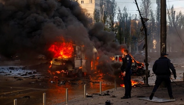 Cars are seen on fire after Russian missile strikes in Kyiv.
