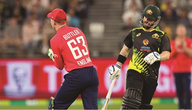 Australiau2019s Matthew Wade (right) runs between the wickets past Englandu2019s wicket-keeper Jos Buttler during the first match of the Twenty20 series at Optus Stadium in Perth on Sunday. (AFP)
