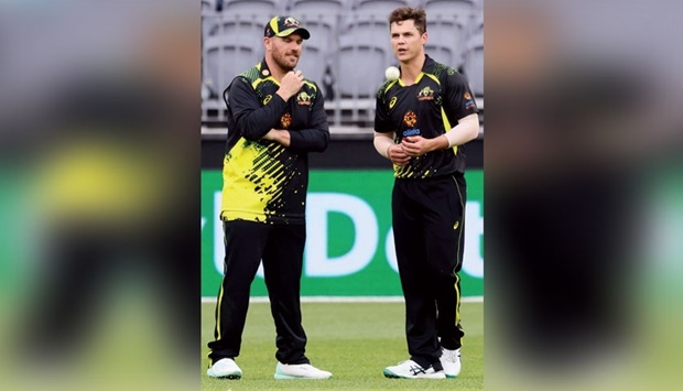 Australiau2019s Aaron Finch (left) talks to spinner Mitchell Swepson during the first match of the Twenty20 series against England at the Optus Stadium in Perth on Sunday. (AFP)