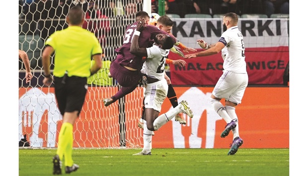 Real Madridu2019s Antonio Rudiger (second right) scores before colliding with Shakhtar Donetsku2019s goalkeeper Anatoliy Trubin and defender Mykola Matviyenko during the Champions League match in Warsaw, Poland, on Tuesday. (Reuters)