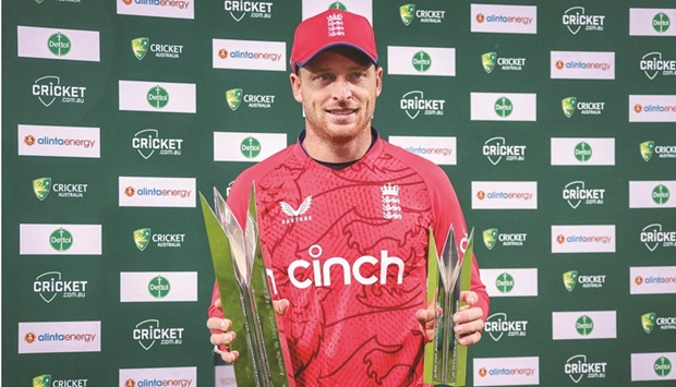 England captain Jos Buttler holds the series winneru2019s trophy and Man of the Series trophy after the third match of the Twenty20 series against Australia at the Manuka Oval in Canberra yesterday. (AFP)