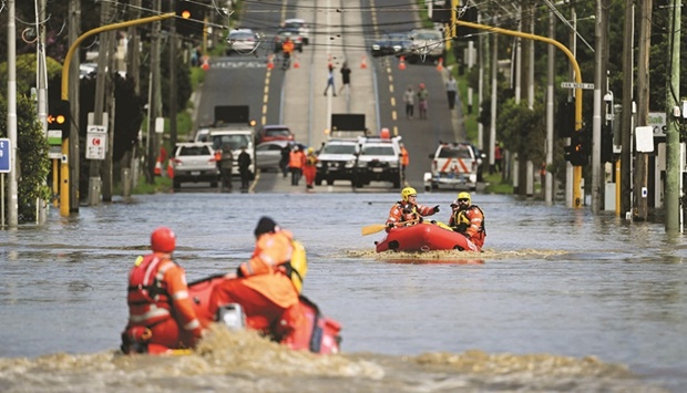 OZ UNDER WATER: Emergency workers patrol a flooded area yesterday as they evacuate residents in the Maribyrnong suburb of Melbourne.