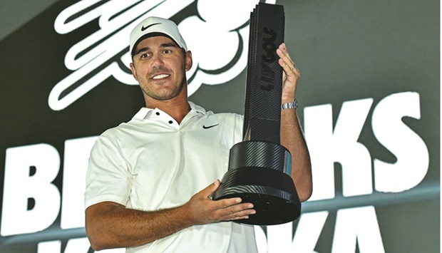 Brooks Koepka celebrates on the podium after his play-off win in the LIV Golf Invitational-Jeddah at the Royal Greens Golf Club yesterday. (AFP)