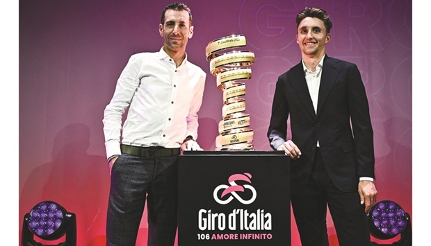 Italian rider Vincenzo Nibali (left) and Australian rider Jai Hindley pose with the u201cTrofeo Senza Fineu201d (Endless Trophy) race winneru2019s trophy  during the presentation of the 2023 Giro du2019Italia cycling race in Milan yesterday. (AFP)