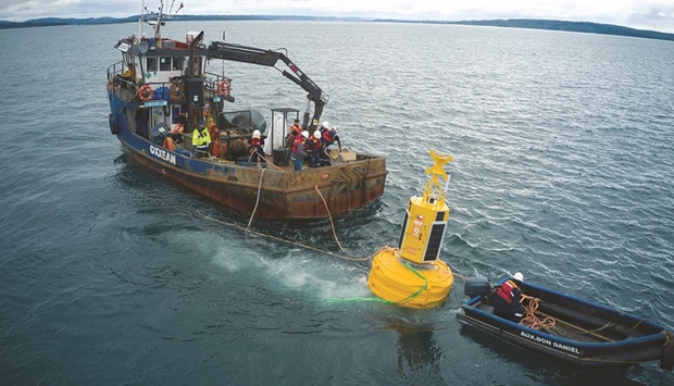 Workers place a buoy called u2018Suyaiu2019 (Hope in Mapuche language) which will help to avoid ship collisions with whales at the u2018Corcovadou2019 gulf area in the coast of Chiloe, Chile.