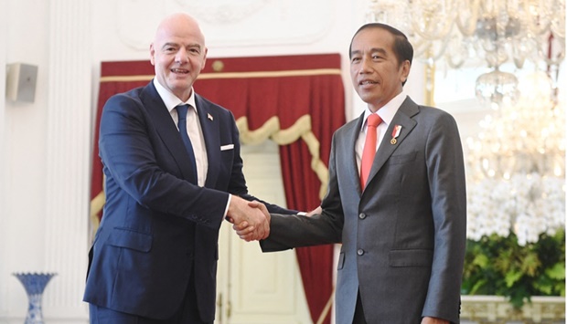 Indonesian President Joko Widodo shakes hands with FIFA?s president Gianni Infantino during their meeting at the Merdeka Palace in Jakarta, Indonesia, October 18, 2022.