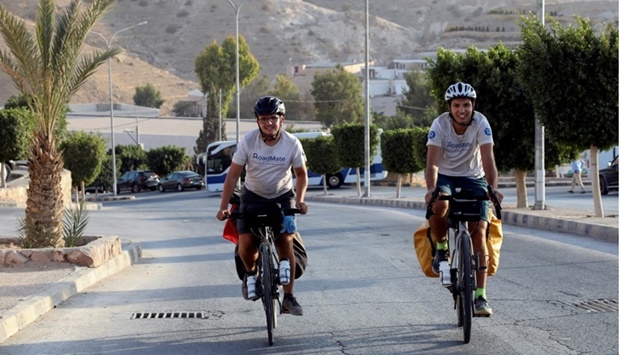 French cyclists Gabriel Martin and Mehdi Balamissa ride their bicycles in Petra, during their stop in Jordan.