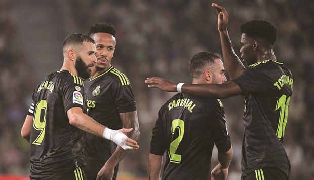 Real Madridu2019s French forward Karim Benzema (left) celebrates with teammates scoring his teamu2019s second goal during the La Liga match against Elche CF at the Martinez Valero Stadium in Elche. (AFP)