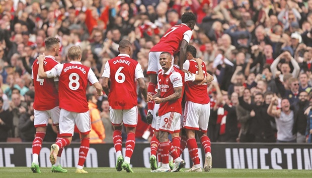 Arsenalu2019s Thomas Partey celebrates with teammates after scoring their first goal against Tottenham Hotspur in London yesterday. (Reuters)
