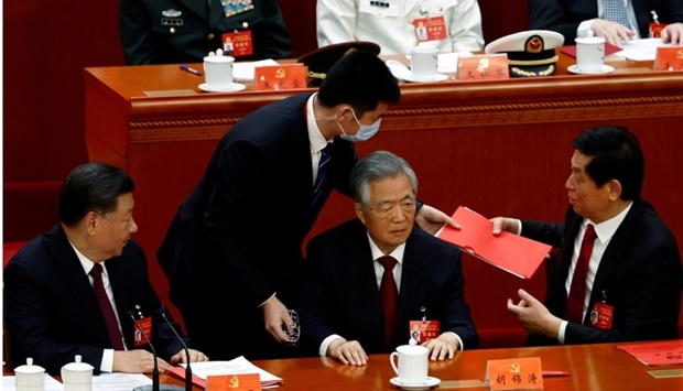 Former Chinese president Hu Jintao is assisted at his seat next to Chinese President Xi Jinping and National People's Congress (NPC) Standing Committee Chairman Li Zhanshu, during the closing ceremony of the 20th National Congress of the Communist Party of China, at the Great Hall of the People in Beijing, China. REUTERS