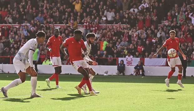 Nottingham Forestu2019s Taiwo Awoniyi (centre) scores against Liverpool during the Premier League at the City Ground in Nottingham, Britain, yesterday. (Reuters)