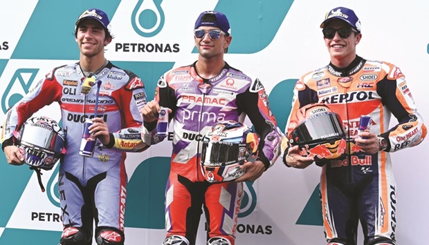 Ducati Gresini Racingu2019s Italian rider Enea Bastianini (left), Prima Pramacu2019s Spanish rider Jorge Martin and Repsol Hondau2019s Spanish rider Marc Marquez (right) pose after finishing first, second and third respectively after the qualifying session of the Malaysian Grand Prix at the Sepang International Circuit in Sepang yesterday. (AFP)