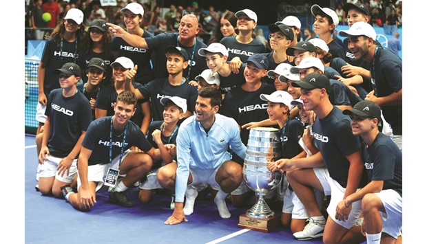 Serbiau2019s Novak Djokovic poses with the trophy and ballboys after  winning the Tel Aviv Open final against Croatiau2019s Marin Cilic. (Reuters)