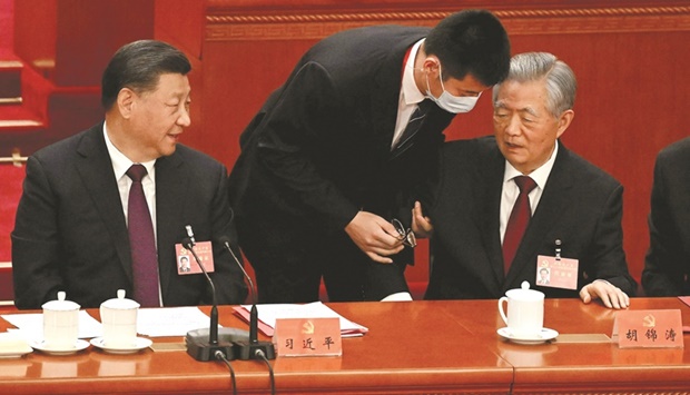 Chinau2019s President Xi Jinping looks on as former president Hu Jintao (right) is assisted to leave from the closing ceremony of the 20th Chinau2019s Communist Partyu2019s Congress at the Great Hall of the People in Beijing, yesterday.