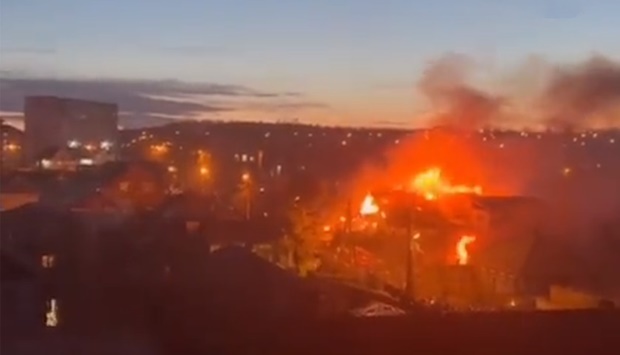 A screengrab from a video shared on social media that purportedly shows fire and smoke billowing from the building into which a Russian military place crashed.