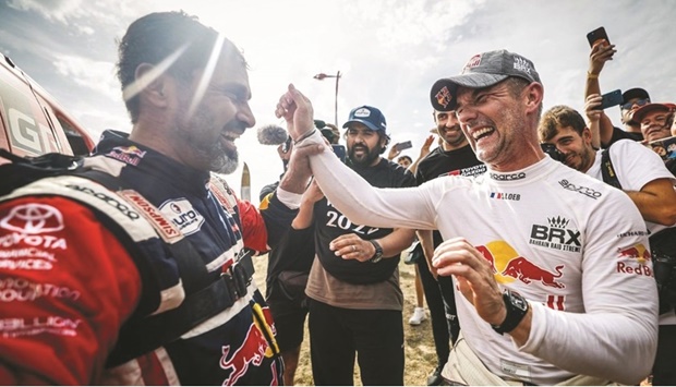Champion Nasser Saleh al-Attiyah and his title rival Sebastien Loeb share a laugh after the Andalucia Rally in Spain on Sunday.