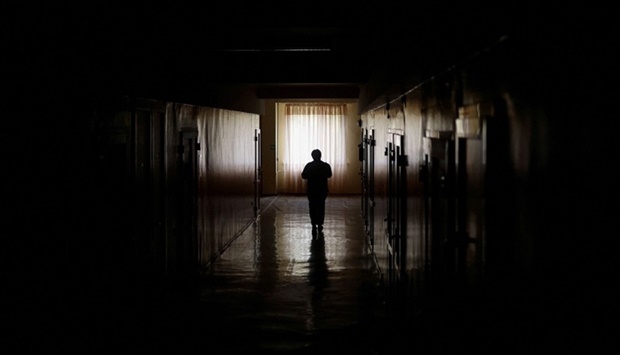 A maternity hospital employee carries to patients meals provided by the NGO World Central Kitchen, during an electricity power cut due to a Russian missile attack, in Mykolaiv, Ukraine. REUTERS