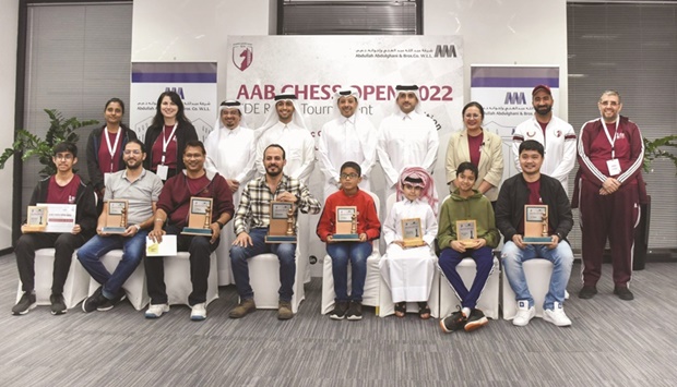 Abdullah Abdulghani & Bros. Co. (AAB) Vice-President Abdulghani Nasser, Qatar Chess Federation president Mohamed al-Mudahka and QCA Executive Director Hamad al-Tamim pose with the winners of the AAB Chess Open FIDE-Rated Tournament.