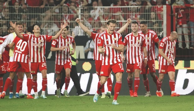 Union Berlinu2019s team celebrates after defender Danilho Doekhi scored a goal during the Bundesliga match against Borussia Moenchengladbach in Berlin yesterday. (AFP)