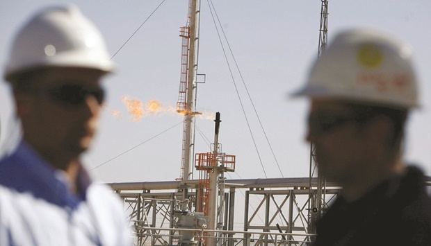 Technicians stand at the Krechba gas treatment plant, about 1,200km south of Algiers (file). State-controlled Algerian energy producer Sonatrach concluded a deal with Italyu2019s Enel last week and said it will soon announce one with Naturgy Energy Group.