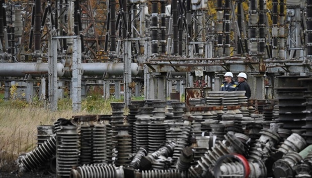 In this file photo, workers examine damage as they repair power line equipment destroyed after a missile strike on a power plant, in an undisclosed location of Ukraine, amid the Russian invasion of Ukraine. (AFP)
